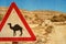 Road sign - camel and corral for camels.