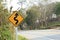 Road sign beside curve mountain road