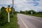 Road sign curved reminds the motorists and vehicles while driving with yellow sign reflecting light to be visible at night at the