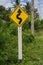 Road sign curved reminds the motorists and vehicles while driving with yellow sign reflecting light to be visible at night at the