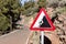 Road sign falling stones