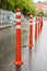 Road sign flexible plastic bollards with pedestrian white marking line and arrow sign on cement floor in parking car