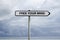 Road sign with FREE YOUR MIND text under cloudy caribbean sky background