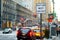 Road sign in New York. Cars, taxi cabs and people rushing on busy streets of downtown Manhattan.