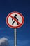 Road sign pedestrians are forbidden to pass with the sky