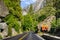 Road sign posted on Highway 120 with stop ahead warning and directions; Yosemite National Park, Sierra Nevada mountains,