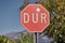 The road sign STOP in Turkish DUR is prohibited in Turkey in front of mountains.