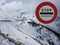 Road sign Stop. Warning of danger in the mountains. Avalanche retreat. Danger on the snow-capped mountain tops among the clouds. T