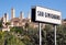 Road sign of town San Gimignano and ancient Tuscan cityscape on background. UNESCO World Heritage Site