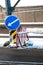 A road sign with a white arrow on a blue background is installed on the roadway. Designation of a dangerous area on the road in