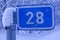 Road sign in winter forest, twenty eighth kilometer