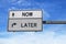 Road sign with words now and later. White two street signs with arrow on metal pole. Directional road  Crossroads Road Sign  Two