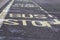 Road signals bus stop yellow word written on asphalt