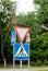 Road signs on a background of trees, give way, pedestrian crossing, traffic rules, road markings
