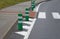 Road signs drawn on the road side. zebra where he must not stop and park. asphalt with the support of green plastic posts. These p