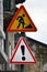 Road signs with an exclamation mark and a man digging the earth. Road works are underway