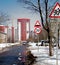 Road signs in the form of speed limitations, warning of children located on the asphalt road in front of the new building