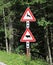 road signs near the forest attention crossing animals cow and de