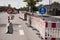 Road signs and roadworks partially blocking a road. Do not turn right and pedestrians and bicycle only signs.