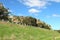 Road, signs, safety barriers and grassy embankment