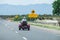 Road signs and three wheeled motorcycle.