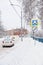 Road signs under the snow near the fence