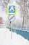 Road signs under the snow near the iron fence