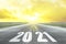 Road and sky in trend colors vibrant Illuminating yellow and ultimate gray with inscription numbers 2021 year, stripes direction