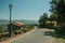 Road on slope with stone parapet and rustic house in Monsanto