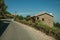 Road on slope with stone parapet and rustic house in Monsanto