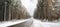 Road through a snow covered forest, slippery and frosty street in winter, empty highway in cold temperature, seasonal weather and