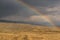 Road steppe rainbow mountains storm