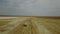 Road in the Steppes of Kazakhstan Muddy River. View on Very Long Road Till Horizon.