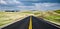 Road surrounded by the green landscapes under the clouded sky