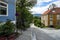 Road surrounded by greenery and houses in the Bakklandet district in Trondheim, Norway