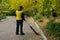 Road sweeper worker cleaning city street with broom tool