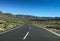 Road though scrubland leading to mountains