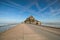 Road to amazing Mont Saint Michel abbey. Tourists are going to the abbey. Normandy, France.