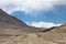 Road to clouds in valley in the foothills of the Fann mountains.