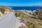 Road to Firopotamos beach with church, houses and cliffs