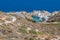 Road to Firopotamos beach with church, houses and cliffs