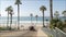 Road to ocean beach California USA. Summertime palm trees. Summer coast near Los Angeles. Sea waves.
