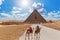 Road to the Pyramid of Menkaure and the bedouin with camels, Giza, Egypt