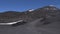 The road to the top of the volcano Etna. People descend from the mountain. Panoramic view of the surface of the volcano