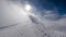 The road with traces of boots to the lift during the start of a snow blizzard on top of the mountain