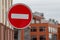 Road traffic sign STOP. Round red white sign at buildings background