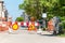 Road traffic sign work ahead with red and white warning barriers on the street construction site in the city
