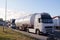 Road transport. Trucks transporting various goods. Photo shows a tanker and a truck for transporting passenger cars
