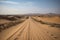 road trip across the desert, with endless sand dunes in the background