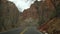 Road trip, driving auto in Zion Canyon, Utah, USA. Hitchhiking traveling in America, autumn journey. Red alien steep